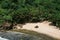 Yogyakarta, Indonesia - January 1, 2022: View from the top of ngetun beach, Gunungkidul.  White sandy beach surrounded by trees