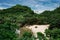 Yogyakarta, Indonesia - January 1, 2022: View from the top of ngetun beach, Gunungkidul.  White sandy beach surrounded by trees