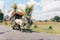 Yogyakarta, Indonesia - November, 2019: Cow cart or Gerobak Sapi with two white oxen pulling wooden cart with hay on road.