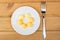 Yolk of boiled eggs in white plate and fork