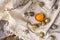 Yolks of broken chicken egg in eggshell and several chicken and