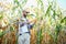 Yong handsome agronomist in the corn field and examining crops before harvesting. Agribusiness concept. agricultural