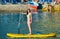 Yong Woman on a Yellow Sup Paddle Board
