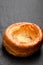 Yorkshire pudding isolated on black stone background