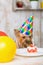 Yorkshire terrier sniffing at the cake.