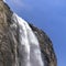 Yosemite Falls plunging down a cliff against sky