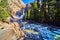 Yosemite Lower Falls in early morning with frosted rocks and ice cold river