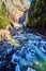 Yosemite Lower Falls in early morning with frosty rocks and icy river