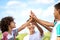 You can always count on siblings to keep you motivated. a group of happy siblings giving each other a high five outdoors