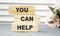 You can help - phrase on wooden blocks with letters, mutual assistance companionship