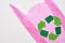 You can make this world better. Recycle symbol at pink plastic bag