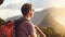 You can travel farther and accomplish more than you think. Shot of a young man admiring the view from the top of a