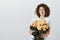 You cannot impress this girl with silly flowers. Disdaining charming curly-haired woman in glasses, holding bucket of