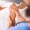 With you every step of the way. Closeup of a unrecognisable persons hand being held by a doctor inside a medical clinic.