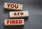 You are fired written on a wooden blocks with copyspace. Crisis labour force cut business concept