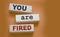 You are fired written on a wooden blocks with copyspace. Crisis labour force cut business concept