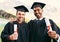 You get what you work hard for. Portrait of two students holding their diplomas on graduation day.