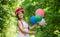It is for you. happy childhood. beautiful girl with party balloons. little girl has fresh blossoming flower of roses in