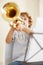 When you know youre amazing, blow your own trumpet. a cute little boy playing the trumpet.