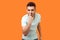 You are liar. Portrait of angry brunette man touching his nose and showing lie gesture. indoor studio shot isolated on orange