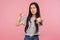 You lost! Portrait of dissatisfied girl with brunette hair in striped t-shirt showing loser or lame gesture