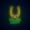 You are lucky - glowing neon inscription phrase with horseshoe sign. Motivation quote in neon style