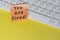 You're Fired text on orange sticky note on top of white keyboard.