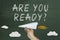 Are you ready text and hand with airplane on green chalkboard