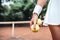 Are you ready to play? Cropped closeup image of a young woman holding tennis balls on court.Healthy lifestyle in tennis club