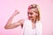 You are stronger than you think Attractive young sporty woman showing her bicep and smiling while standing against pink