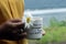 You are stronger than your scars. Motivational text message on coffee cup with flower in a woman hands.