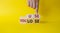 You use or lose symbol. Businessman hand points at cubes with words You lose or You use. Beautiful yellow background. Business and