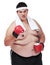 You want some of this. A studio shot of an obese young man wearing boxing equipment and waving a fist at the camera.