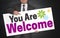 You are Welcome poster is held by businessman