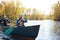 You wont find them stuck indoors on the weekend. a young couple going for a canoe ride on the lake.