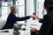 You wont regret consulting with me. a mature businesswoman shaking hands with a colleague during a meeting in a modern