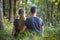 Youg couple, man and a woman sitting together outdoors enjoying nature