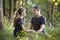 Youg couple, man and a woman sitting together outdoors enjoying nature