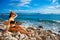 Youg girl in bikini sitting on beach