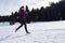 Yougn woman jogging outdoor on snow in forest