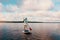 Youll never regret time on the water. a young woman paddle boarding on a lake.