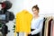 Youn asian woman fashion blogger showing cloth with smiling face while recording new content for vlog and fashion online shopping