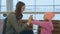 Yound mother and little cute daughter having fun at airport.