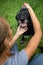 Younf woman combing out the fur of a black dog