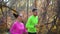 Young active couple jogging outside in autumn