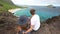 Young active couple sitting and looking at view in Makapuu Lookout, Oahu, Hawaii