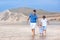 Young active father at beautiful beach with his kids