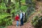 Young active father hiking in cliff and forest with kids