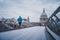 Young active man running at Millennium Footbridge over the Thames, St Paul`s Cathedral in background