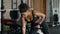 Young active motivated african american woman athlete pumping dumbbell at gym, working out on chest muscles